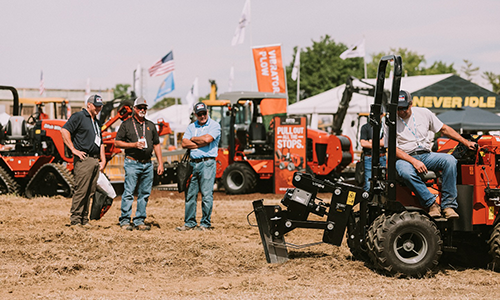 three guys standing around a trencher