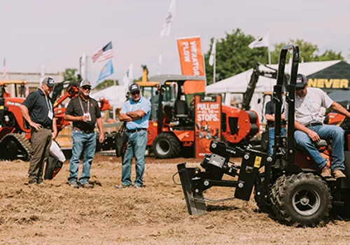 three guys standing around a trencher
