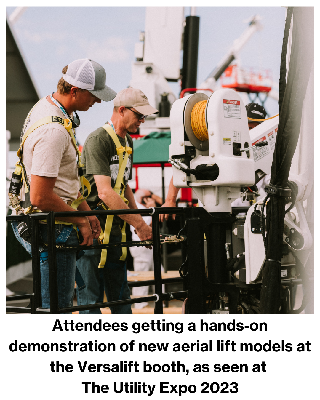 Attendees getting a hands-on demonstration of new aerial lift models at the Versalift booth, as seen at  The Utility Expo 2023