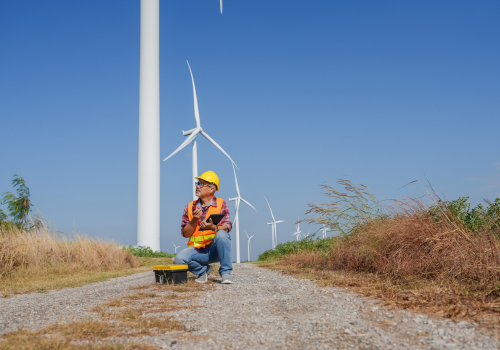 Portrait of a Senior Male Wind Turbine Maintenance Engineer Using a Tablet to Check Weather Conditions at a Wind Farm Renewable Energy Wind Power Thailand
