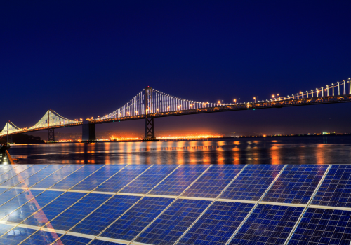 Solar Power Station over Bay Bridge at night. The city is San Francisco, California, USA.