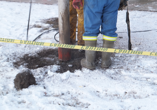 Vacuum excavation truck excavating in winter frozen ground 