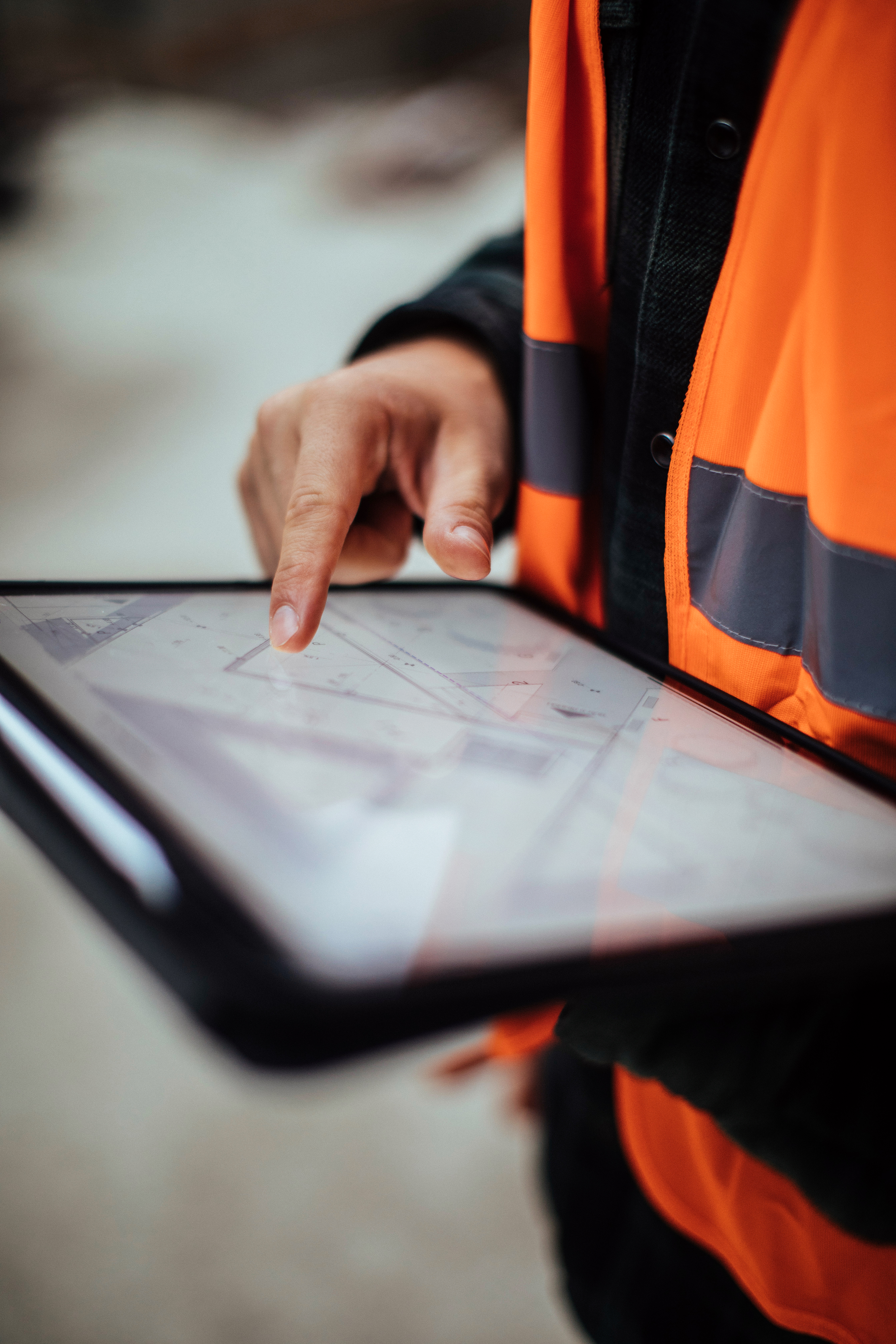 Unrecognizable construction worker using a digital tablet while working at a building site