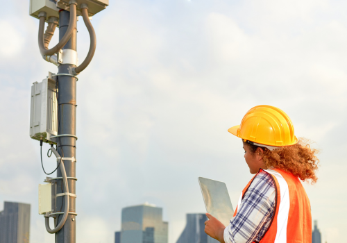 African American female engineer was checking the readiness of a communication tower.