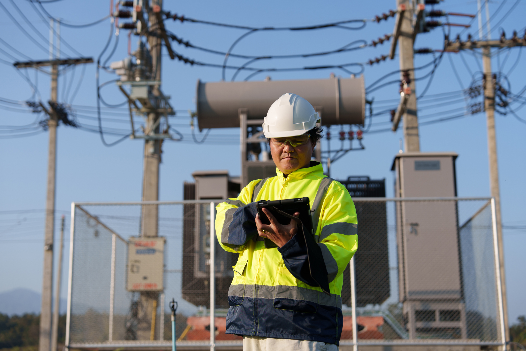 An expert engineer is inspecting a high-voltage transformer in a remote rural area.