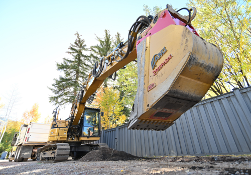 Excavator breaking ground jobsite 