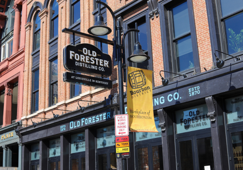 Louisville, Ky, USA. A middle aged woman walks along Main Street looking at the historic architecture in an area once known for its numerous distilleries.