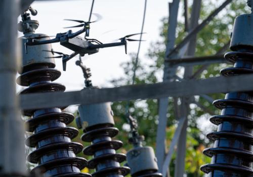 Drone inspecting powerline tower