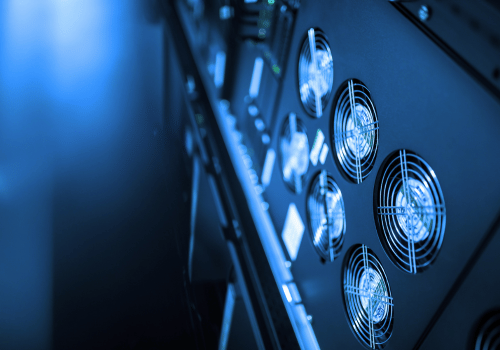 A close-up view of server cooling fans in a modern data center, showcasing advanced technology for efficient airflow and temperature regulation in high-performance computing environments.
