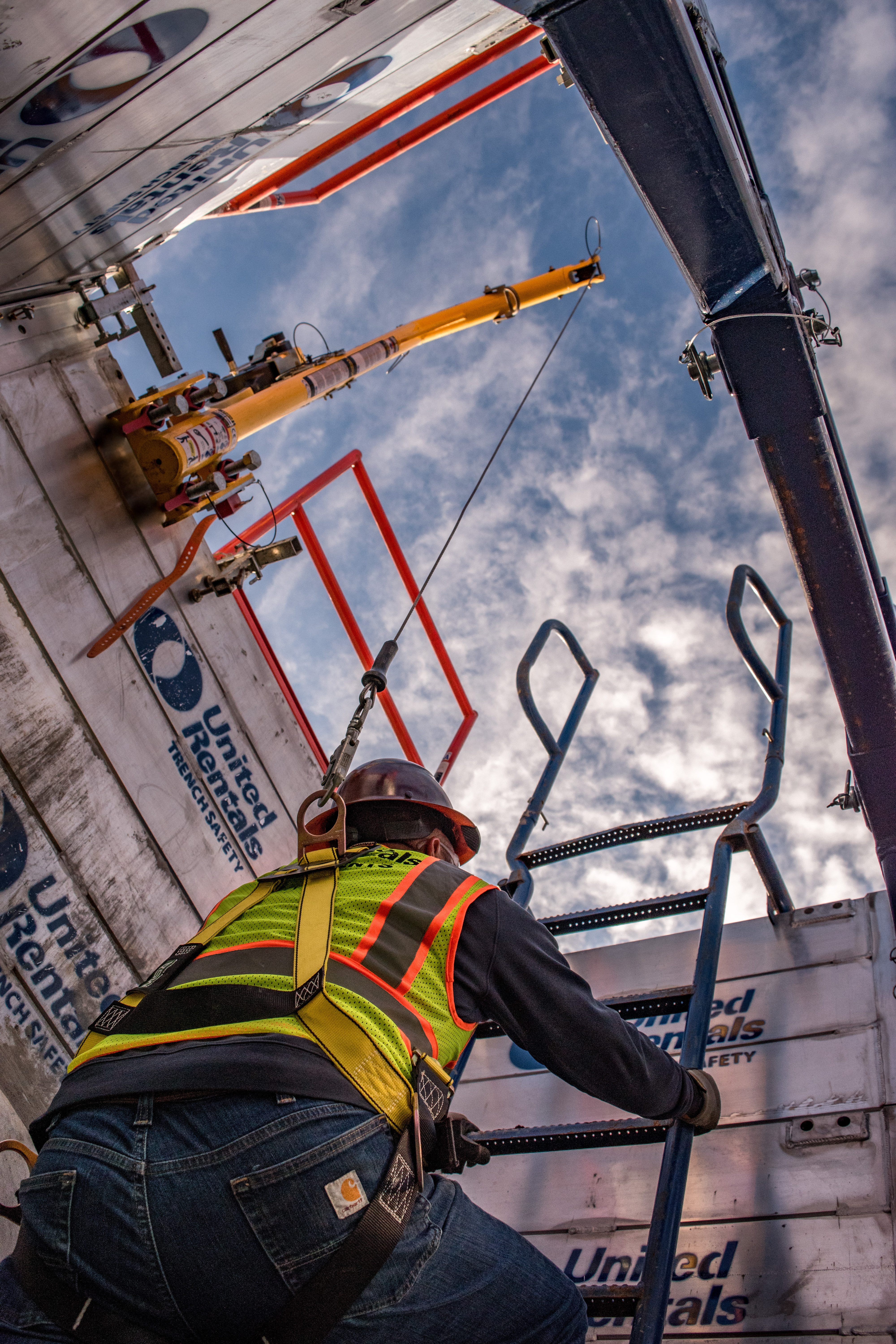 Construction worker working in trench using trench box