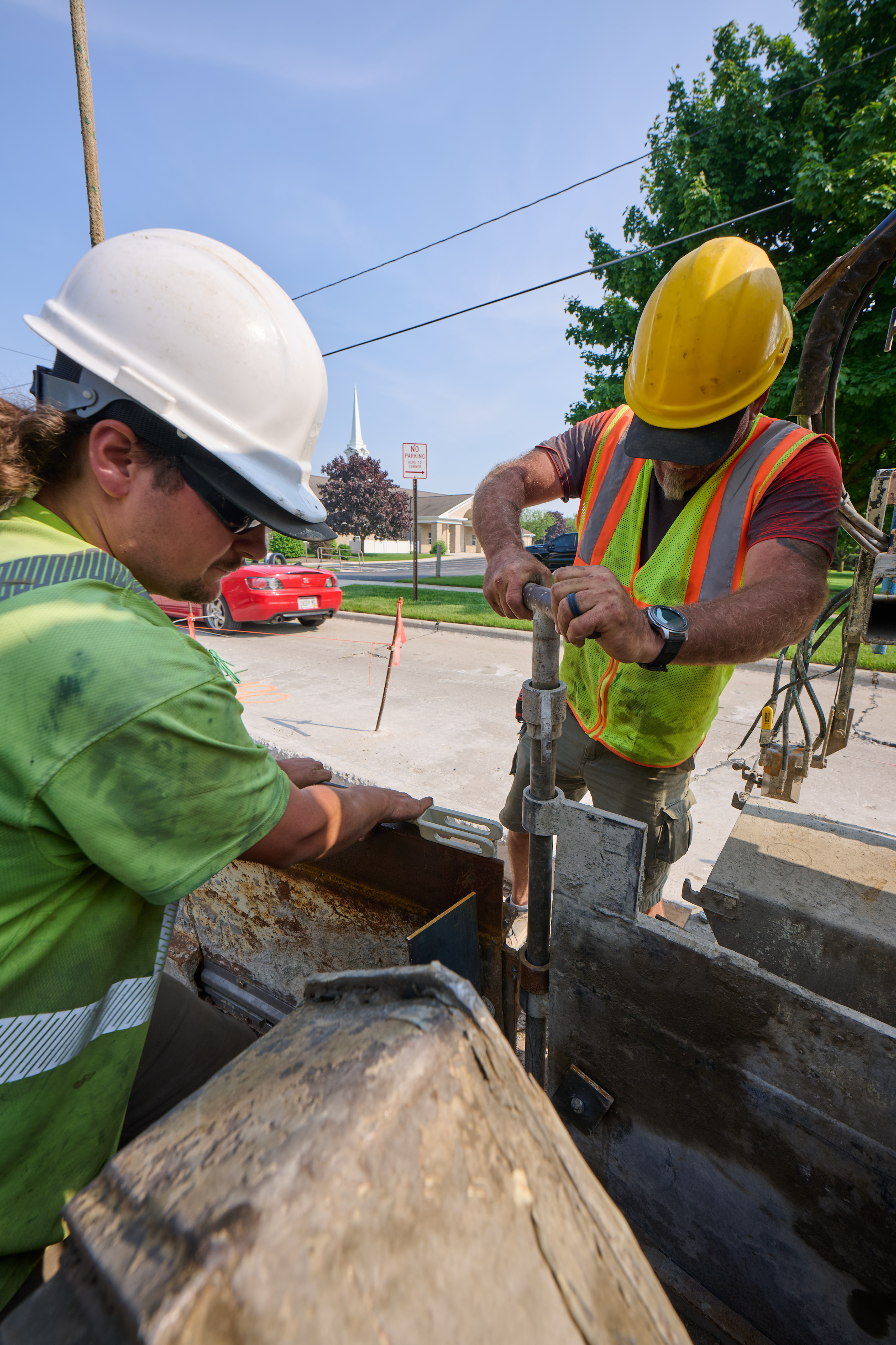 Photo of two construction workers working together on a jobsite