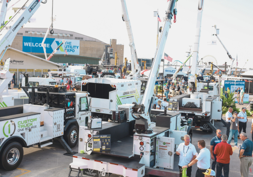 Aerial shot of a large outdoor trade show with lots of aerial lifts 