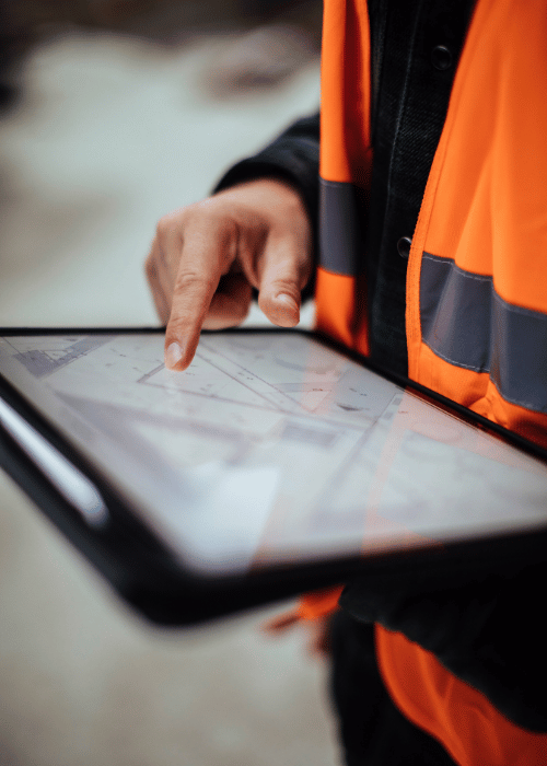 Unrecognizable construction worker using a digital tablet while working at a building site