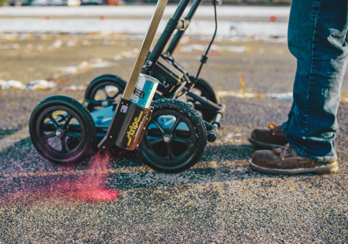 Marking underground utilities with paint parking lot