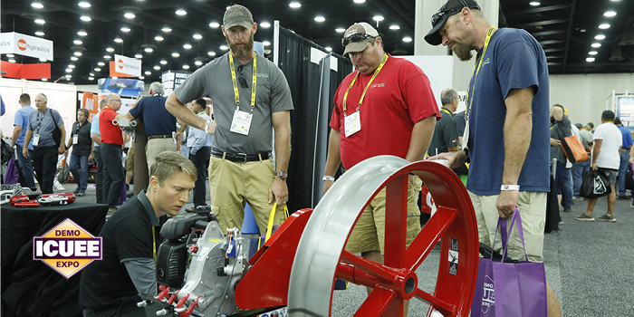 ICUEE Attendees look at a machine