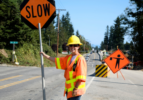 Construction Woman on the job site flagging traffic