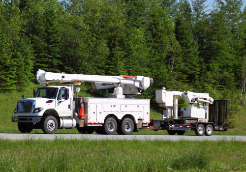 Power corperation truck with boom, On the trailer is another boom unit with caterpillar tracks. Selective focus on the vehicles.