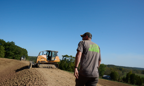 Construction worker walking to truck 