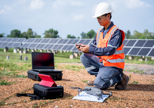 Engineers preparing drones to fly, inspecting the solar cells at high angles to thermo scan the solar panel for potential malfunctions and overheating. Alternative energy to conserve world's energy.