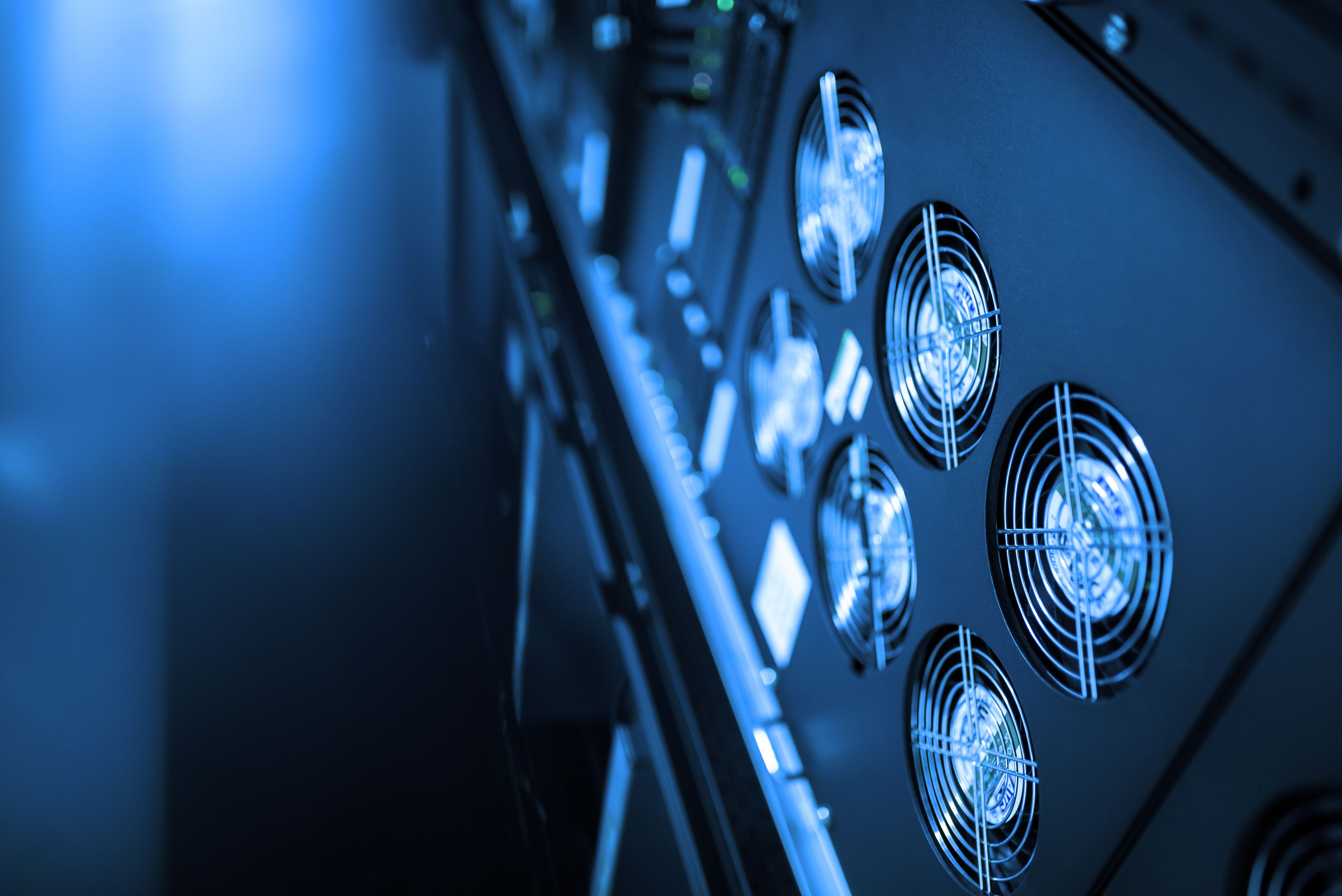 A close-up view of server cooling fans in a modern data center, showcasing advanced technology for efficient airflow and temperature regulation in high-performance computing environments.