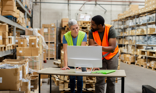 Man and woman working in a shipping warehouse