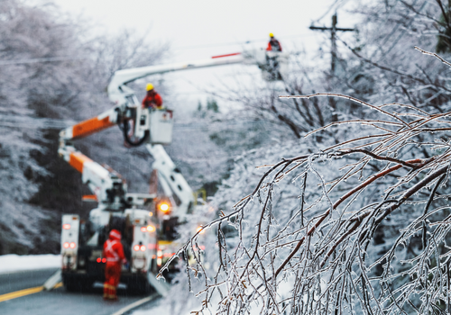 Lineworkers work to restore power during an intense ice storm.